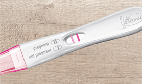 First Response pregnancy test displaying a "pregnant" result.